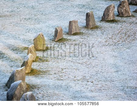 The Big Stones Standing In The Snow Field In Winter
