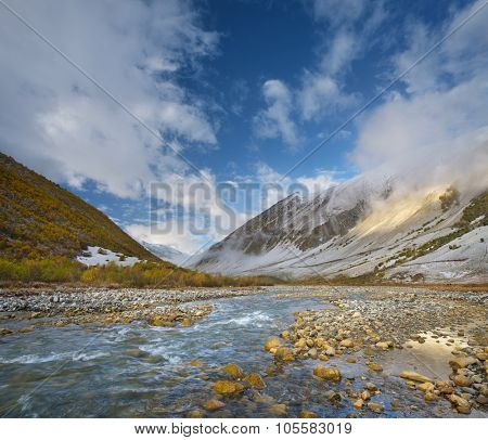Autumn landscape with the first snow. River in the mountains. Valley Enguri river. Caucasus. Zemo Svaneti, Georgia