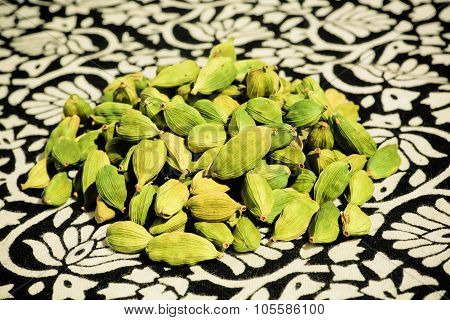 Green Grains Of Cardamom On A Patterned Table
