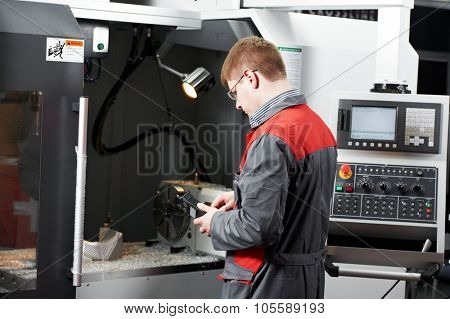 mechanical technician service engineer worker at cnc metal machining milling center in tool workshop