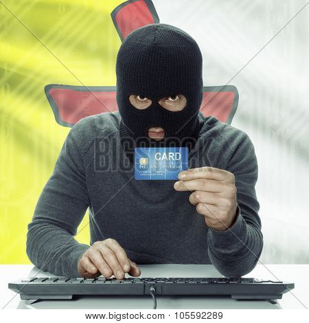 Dark-skinned Hacker With Canadian Province Flag On Background Holding Credit Card - Nunavut