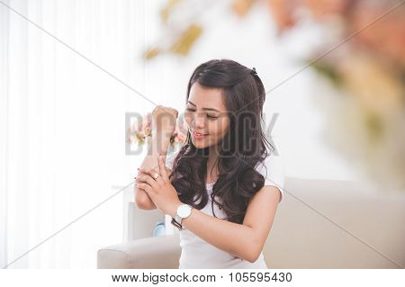 Woman Applying Lotion Into Her Skin