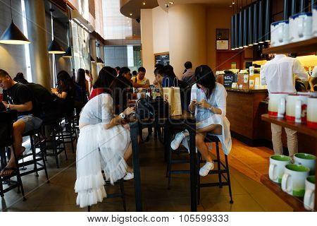 SHENZHEN, CHINA - OCTOBER 15, 2015: Starbucks Cafe interior. Starbucks Corporation is an American global coffee company and coffeehouse chain based in Seattle, Washington