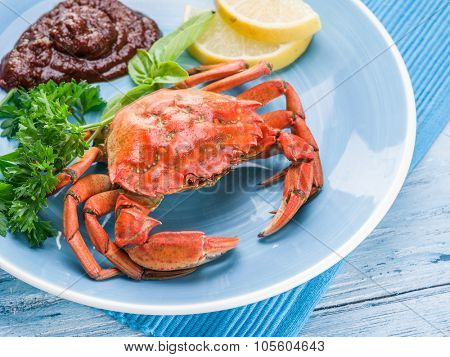 Seafood dish - cooked crab with lemon and herbs.