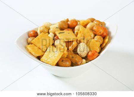 bowl of rice crackers on white background