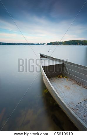 Lake Shore With Moored Boat. Long Exposure