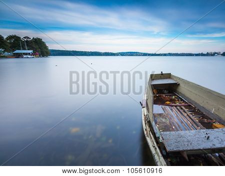 Lake Shore With Moored Boat. Long Exposure