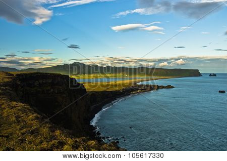 Sunset on black beach, a view from Dyrholaey rock, Iceland