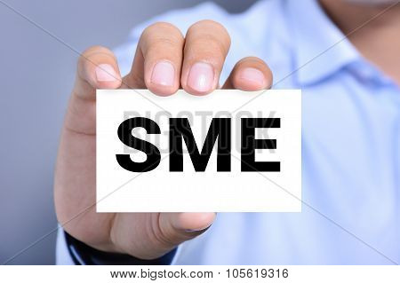 Sme Letters (or Small And Medium-sized  Enterprises) On The Card Shown By A Man