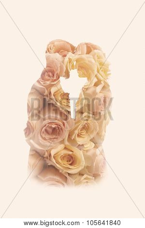 Double exposure portrait of a wedding couple combined with roses from the wedding bouquet
