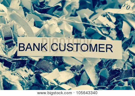 papierschnitzel tagged with bank customer, photo icon for data destruction, customer data and bank secrecy