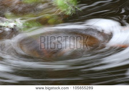 Blurred Vortex In Water With Spray Plant Parts