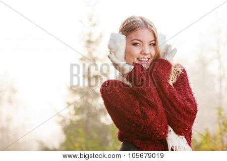 Portrait Of Pretty Smiling Woman In White Earmuffs.
