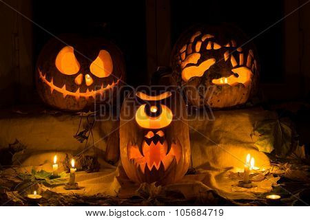Photo Composition From Three Pumpkins On Halloween.