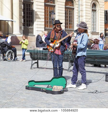 STOCKHOLM, SWEDEN - May 21, 2015: Unidentified strolling musicians play guitars on Stortorget square in Stockholm