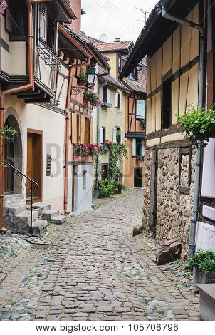 Street with half-timbered medieval houses in Eguisheim village along the wine route, Alsace, France