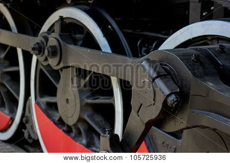 Railroad wheel dark and red.