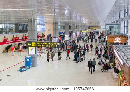 HANOI, VIETNAM, DECEMBER 21, 2014 : Large view on the NoiBai international Airport and the passengers queueing at the check-in counters of Vietjet airline in Hanoi, Vietnam   