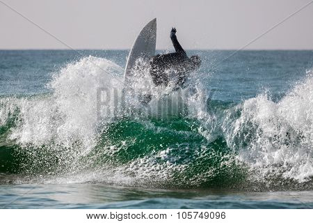 Surfing riding the wave with lots of splashes