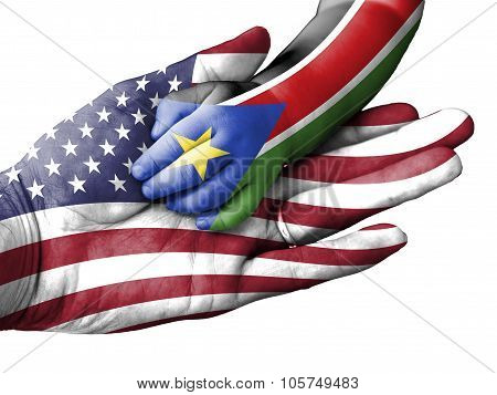 Adult Man Holding A Baby Hand With United States And South Sudan Flags Overlaid. Isolated On White