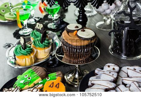Food table arrangement prepared for Halloween party.