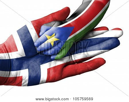 Adult Man Holding A Baby Hand With Norway And South Sudan Flags Overlaid. Isolated On White