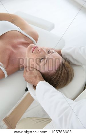 Chiropractor touching woman's head