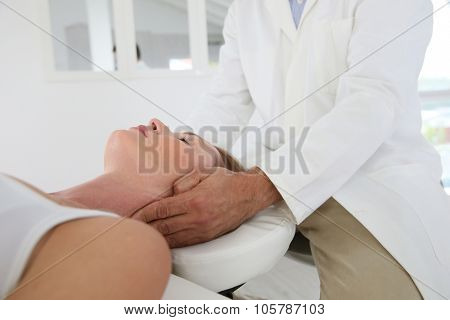 Chiropractor touching woman's head
