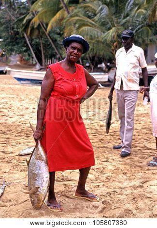 Woman holding a large fish, Tobago.