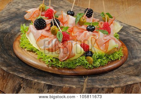 Galia Melon, Melon With Ham, Raspberries, Blueberries, Blackberries And Olives