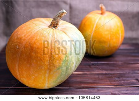 Two Big Pumpkins On A Table