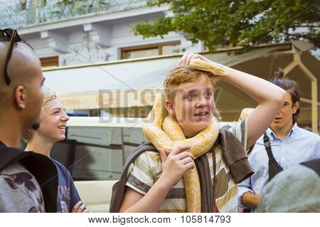Red-haired Boy With A Huge Yellow Boa Snake