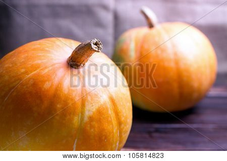 Two Big Pumpkins On A Table