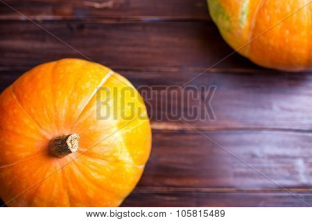 Two Pumpkins Lie On A Table
