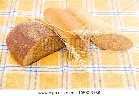 Different Types Of Bread And Spikes On A Checkered Tablecloth