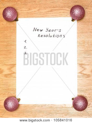 New Year's Resolutions On A Blank List On Wooden Background