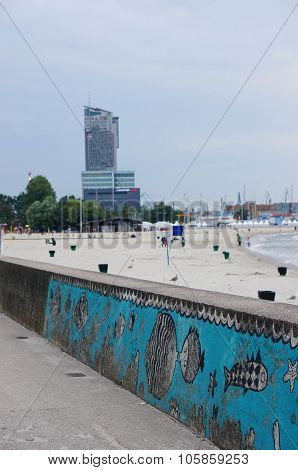 GDYNIA POLAND - JULY 27 2015: Fish drawings on a wall by a beach in the evening