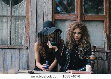 Two vintage witches perform magic ritual