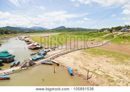 Wooden Bridge And Houses In Water