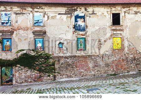 Abandoned House With Paintings In Windows