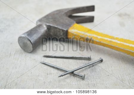 Old Rust Hammer And Nails On Wood Board