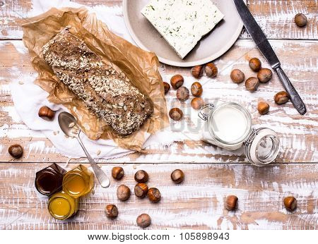 Bread With Seeds Huzelnuts And Cheese On Board