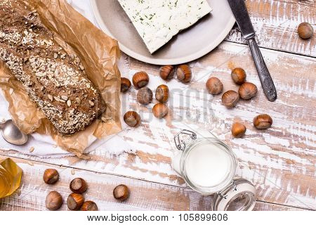 Tasty Bread With Seeds Huzelnuts And Cheese On Board