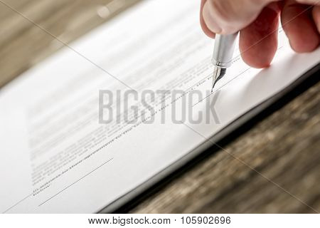 Man Signing Business Document, Subscription Form Or Insurance Papers With Silver Pen