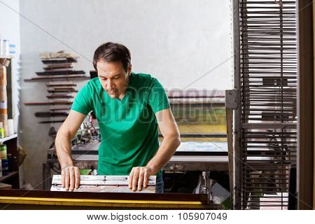 Silkscreen artist in atelier creating artwork