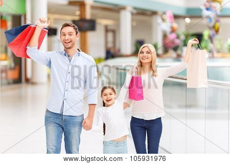 Friendly family walking around shopping mall