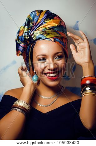 beauty bright african woman with creative make up, shawl on head like cubian closeup