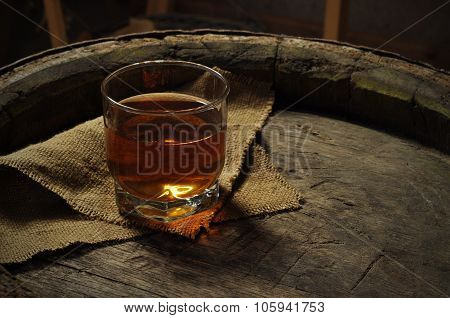 Glass white wine and bunch grapes on background of wooden