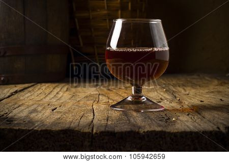 Glass white wine and bunch grapes on background of wooden