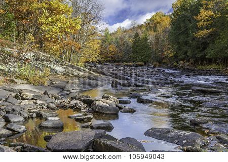 River Flowing Through A Forest In Autumn - Ontario, Canada